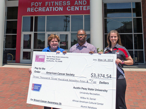 Henderson Hill III (center), director of the Wilbur N. Daniel African American Cultural Center at APSU, and Lauren Wilkinson (right), assistant director of the APSU University Recreation, present a check to Jerri Rule, community representative with the American Cancer Society. The proceeds are from the annual Breast Cancer Awareness 5K held April 13th on the main APSU campus. (Photo by Beth Liggett, APSU photographer)