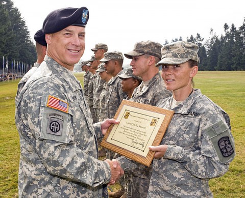 Maj. Gen. Jefforey Smith, commander of the U.S. Army Cadet Command, presents Cadet Cynthia Stinnett with a plaque for earning the top Army physical fitness test score. (Photo provided)