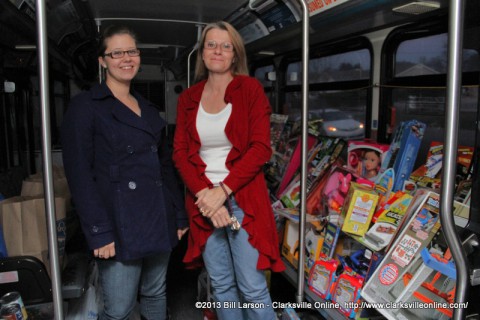 Rachel Rainey and Lori Mahaffey from Movement Mortgage with the donations for the Stuff the Bus Campaign