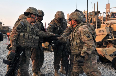 Soldiers with 2nd Platoon (Lancers), 51st Transportation Company, 77th Combat Sustainment Support Battalion, in support of Task Force Lifeliner, gather around in a team huddle after prepping their mine resistant ambush protected vehicle as part of preparation for upcoming missions, Dec. 22, 2013 at Bagram Air Field, Parwan province, Afghanistan. (U.S. Army photo by Sgt. Sinthia Rosario, Task Force Lifeliner Public Affairs) Soldiers with 2nd Platoon (Lancers), 51st Transportation Company, 77th Combat Sustainment Support Battalion, in support of Task Force Lifeliner, gather around in a team huddle after prepping their mine resistant ambush protected vehicle as part of preparation for upcoming missions, Dec. 22, 2013 at Bagram Air Field, Parwan province, Afghanistan. (U.S. Army photo by Sgt. Sinthia Rosario, Task Force Lifeliner Public Affairs)