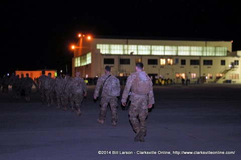 The returning soldiers approach the hanger and their waiting families