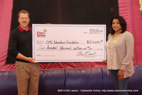 Tom Beach presents Candy Johnson from the Clarksville-Montgomery County Education Foundation a  $200,000 check.