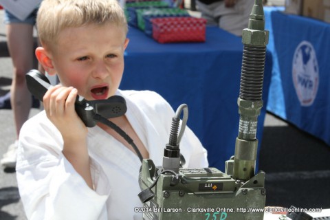 A young boy tries out the 5th Special Forces Group Satcom Gear at the 2014 Rivers and Spires Festival