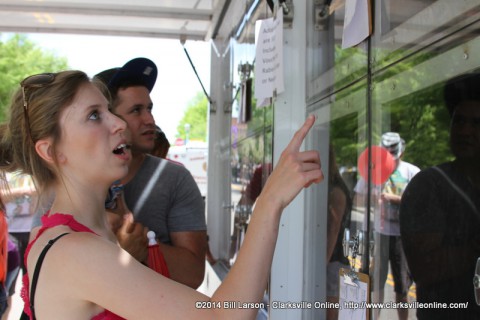 A young couple picks out an animal that they like in the Montgomery County Animal Control Mobile Adoption Trailer at the 2014 Rivers and Spires Festival