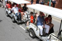 Festival Director Jessica Goldberg (right front) rides with the former Festival Director Doug Barber and other dignitaries in the Children's Parade at the 2014 Rivers and Spires Festival in Historic Downtown Clarksville