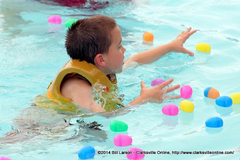 A young man reaches for two eggs at once at the City of Clarksville's Wettest Egg Hunt on Saturday