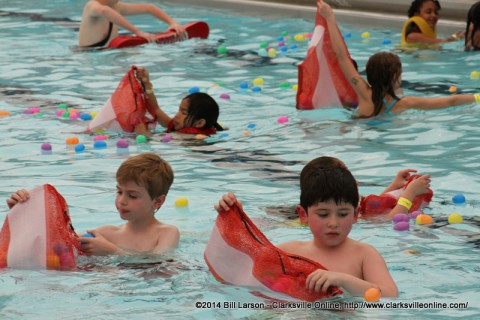 Children gather eggs from the Pool at the Indoor Aquatic Center during the Wettest Egg Hunt on Saturday