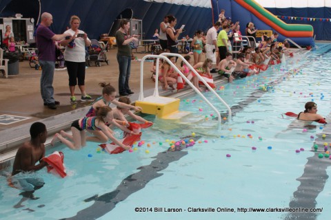 Children lining the edge of the pool as the signal is given to go into the pool at the City of Clarksville's Wettest Egg Hunt on Saturday
