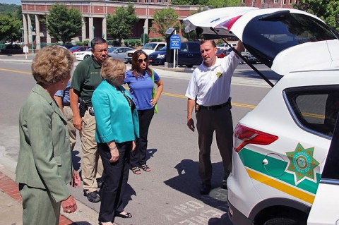 Fuson shows Mayors Carolyn Bowers and Kim McMillan the 2014 Ford Escape.