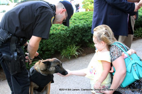 A young lady meets Deputy Eric Trout and his K-9 partner Fuse