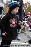 A young man watches the 2014 Veterans Day Parade