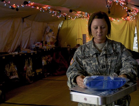 Capt. Melanie Bowman, a Camden, Tenn., native and officer in charge for the 86th Damage Control Resuscitation Team, 86th Combat Support Hospital, Fort Campbell, Ky., prepares medical supplies at the Joint Forces Command – United Assistance Field Hospital, Dec. 16, 2014. The field hospital has the equipment and personnel to address any immediate medical emergency in theater. (Sgt. Dani Salvatore, 27th Public Affairs Detachment)