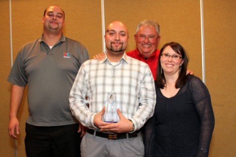 James Jenkins receives the "Rising Star" award from Convenient Car Care Inc. during the annual Christmas and Employee Recognition dinner.  Pictured are Brian Banning, Jenkins, Doug Wall, and Candace Ursery (Bill Larson/Clarksville Online)