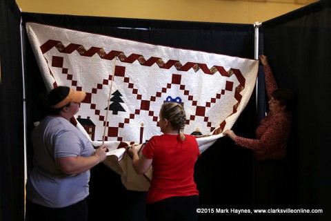 Quilts being hung for the Rivers and Spires Quilts of the Cumberland Quilt Show.