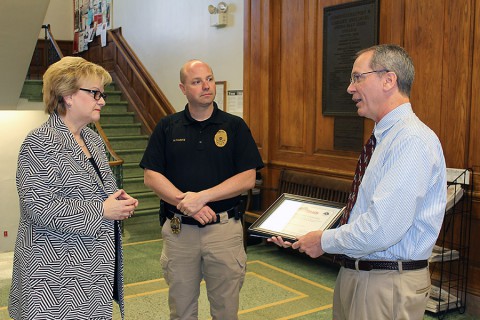 APSU president, Dr. Alisa White stands as Larry Vannozzi of the National Weather Service explains the designation to APSU Police Chief, Michael Kasitz. (APSU / Charles Booth)