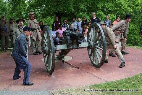 Kenwood Elementary School 5th Graders watch the 14th Tennessee Infantry reenactors demonstrate how artillery was fired at Fort Defiance Civil War Park, Friday.