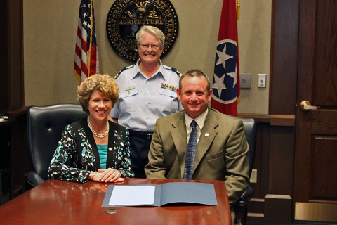 Jim Durrett, Mayor of Montgomery County and Kim McMillian,  Mayor of the City of Clarksville, standing Diane Gilman, USCG Auxiliary Flotilla Commander 082-11-07, Clarksville/Fort Campbell.