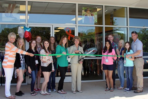 Plato's Closet green ribbon cutting ceremony. (L to R) Melinda Shepard; Ashley, Leslie, Nicole, Amanda, Vivian, Brandy Vaughn, Mayor McMillan, Stephanie, Chris, Taylor, Hannah and Jim Vaughn.