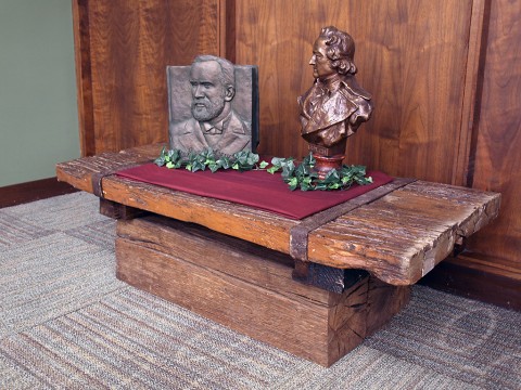 On display at Austin Peay State University’s Woodward Library is a table made from salvaged material from the old Port Royal covered bridge. The table was created by Larry Ellis and Kenny Bishop, two APSU alums, in 1971. Also on the table are sculptures of founder of the Dewey Decimal system, Melvil Dewey (left) and author Johann Wolfgang von Goethe (right). (Scott Summate, APSU)
