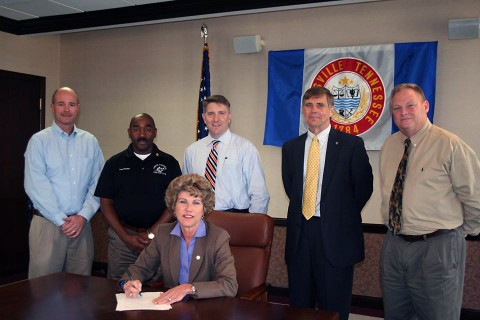 Clarksville Mayor Kim McMillan signs Memorandum of Understanding for the construction of a new splash pad and playground areas in Heritage Park.