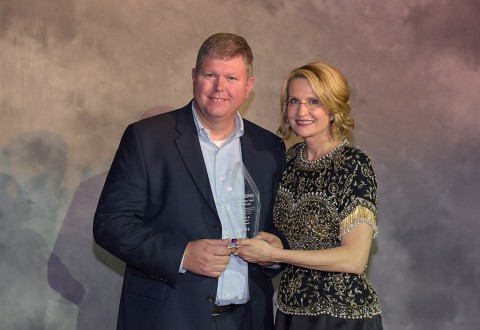Lincoln Barnard, owner of FASTSIGNS of Clarksville, receiving the Rookie of the Year Award from Catherine Monson, CEO of FASTSIGNS International, Inc.