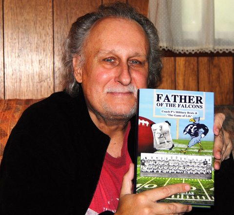 Arthor Rob Dollar with his book “Father of the Falcons: Coach P’s Military Brats & ‘The Game of Life’”