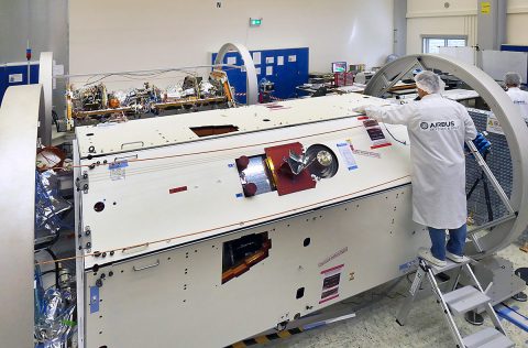 A technician inspects one of the two satellites for NASA's Gravity Recovery and Climate Experiment Follow-On (GRACE-FO) mission at the Airbus Defence and Space manufacturing facility in Friedrichshafen, Germany. The other GRACE-FO satellite is visible in the background. (Airbus DS GmbH-A.Ruttloff 2016)