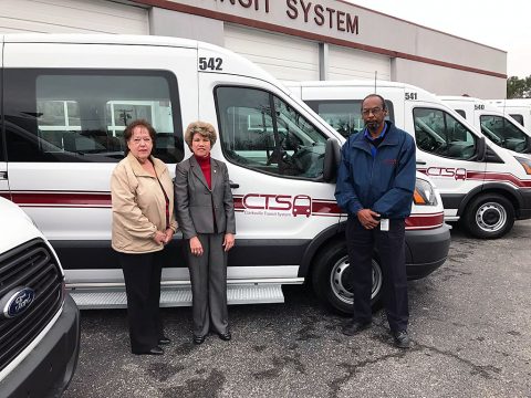 Clarksville Mayor Kim McMillans stands long side the new Clarksville Transit System Paratransit Vehicles.