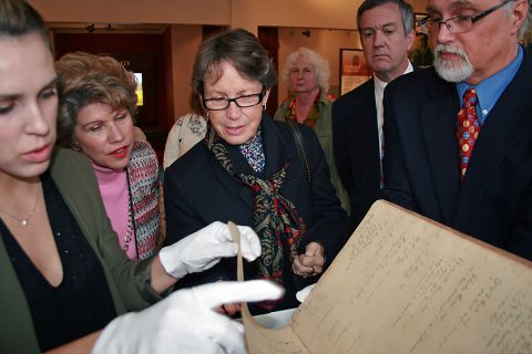 Kali Mason, Customs House Curator of Collections, carefully handles pages of the diary of Serepta Jordon as Mayor Kim McMillan, Millie Armstrong, Tenessee Secretary of State Tre Hargett and Customs House Executive Director Jim Zimmer look at the fragile document. Hargett delivered a $3,000 state grant check to the museum Thursday that will be used to continue the restoration of the historic diary.