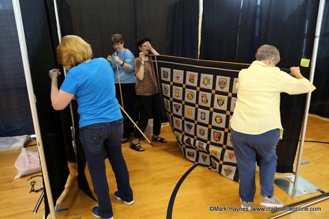 Volunteers preparing the quilts for Clarksville's Rivers and Spires Quilts of the Cumberland exhibit.