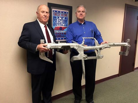 IDB Chairman Billy Atkins and Shiloh Plant Manager Gerald Craycraft hold a magnesium dashboard panel manufactured at the Shiloh plant in Ireland. 