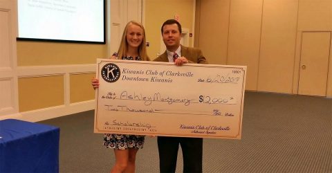 Kiwanis President Daniel Binkley presents a scholarship check to Ashley Montgomery