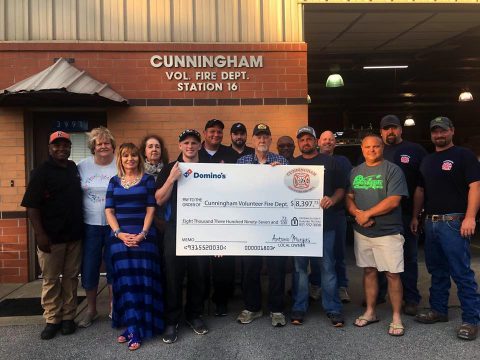 Cunningham Volunteer Fire Department receives check for $8,397.73 from Domino's on Highway 48 owner Antonio Murgas.