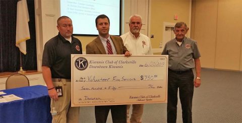 Randy Steeley, Ed Baggett and Jerry Buchanan with the Montgomery County Volunteer Fire Service accept a check presented by Kiwanis President Daniel Binkley.