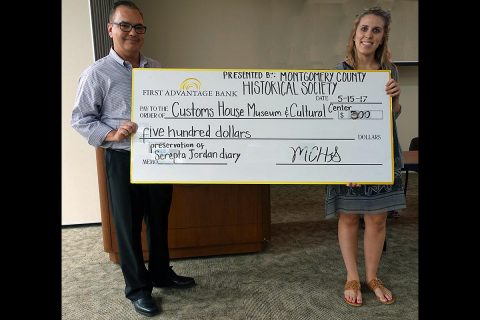 Customs House Curator of Collections Kali Mason receives a $500.00 check from Jeff Harris, treasurer of the Montgomery County Historical Society, to help pay for restoration of the journal kept by New Providence resident Serepta Jordan from 1857 to 1864.