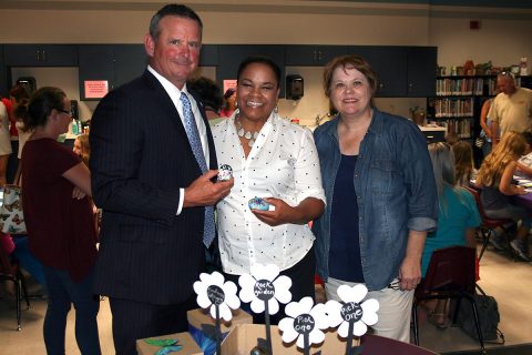 Montgomery County Mayor Jim Durrett, Clarksville Mayor Pro Tem Valerie Guzman, and Rita Arancibia show off some Kindness Rocks at the Public Library.