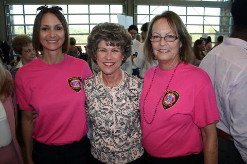 Clarksville Mayor Kim McMillan congratulates Gina Mills (left) and Susan Harris for their work selling pink Clarksville Fire Rescue T-shirts, raising a $2,500 donation to the YMCA's ABC Program.