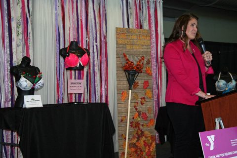 Angela Piekielko, local ABC Program coordinator, addresses the Tickle Me Pink crowd and shares the stage with several entries in the Battle of the Bras competition.