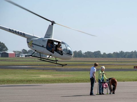 Attendees at the Wags & Wings Family Fun Fest enjoy helicopter rides, October 14th. Airplane and helicopter rides were part of the inaugural event at Clarksville Regional Airport, which raised awareness for the Humane Society of Clarksville-Montgomery County and its mission. (Josh Vaughn)