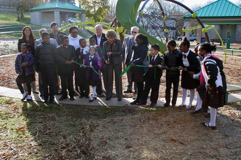 Clarksville Mayor Kim McMillan, Clarksville Parks and Recreation Director Jennifer Letourneau, members of the Clarksville City Council and students from Tabernacle Christian School cut a ribbon Monday formally reopening Valleybrook Park.