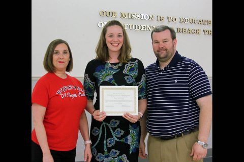 Pisgah Elementary Principal Sallie Oden and School Board member Josh Baggett congratulate Amber Hartzler.