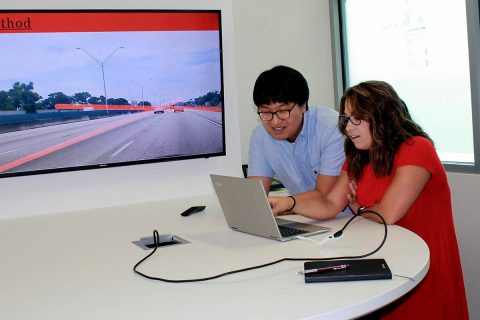 APSU senior Jordan Miller shows her program to Florida Atlantic University mentor Dr. Jinwoo Jang during her summer undergraduate research project. Miller researched a self-driving car program to help identify and report missing or incomplete lanes on roads.