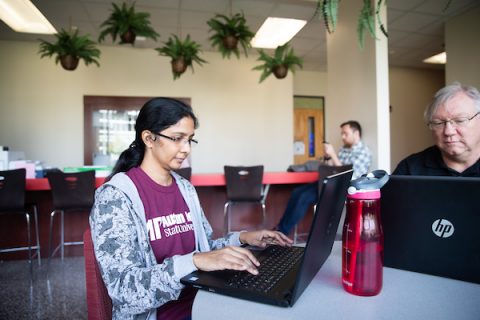 Austin Peay State University grad students Farjana Anwerbasha and Gary Larson look over coding projects at APSU.