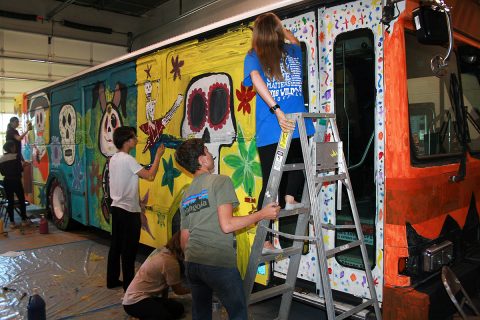 Clarksville Academy students gathered Monday to paint the Spooky Special, a Clarksville Transit System bus that will offer free rides on selected routes on October 30th-31st.