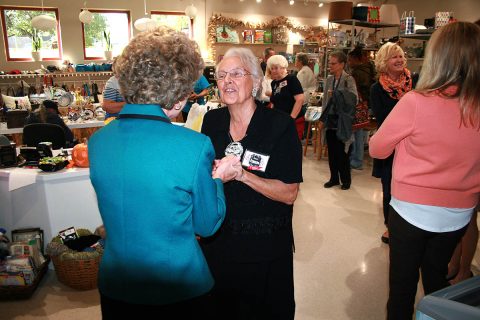 Clarksville Mayor Kim McMillan greets a member of the big crowd that gathered Friday day for the dedication of the new thrift store at the Ajax Turner Senior Citizen Center in Clarksville.