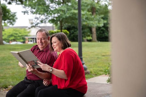 Alisha Jerles Horn and her father, Dr. Joe Jerles, look at an old Austin Peay yearbook.