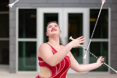 Austin Peay State University's Izzy Melvin specializes in twirling three batons simultaneously. During home football game halftime shows and other events, such as the Homecoming bonfire celebration, she lights them afire.