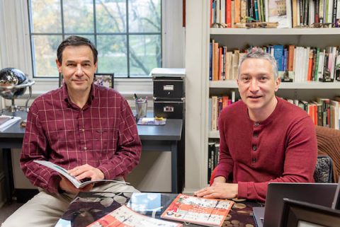 Austin Peay State University professors Dr. Sergi Markov and Dr. Osvaldo Di Paolo Harrison review the first issue of "Explore Your World."