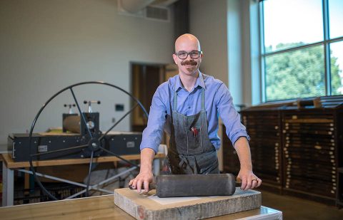 Patrick Vincent, APSU assistant professor, poses in the printmaking studio.