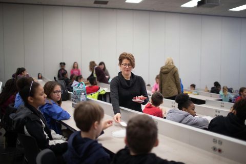 Austin Peay State University biology professor Dr. Mollie Cashner hands out supplies so the Moore Magnet Elementary fifth-graders can record their experiment results.
